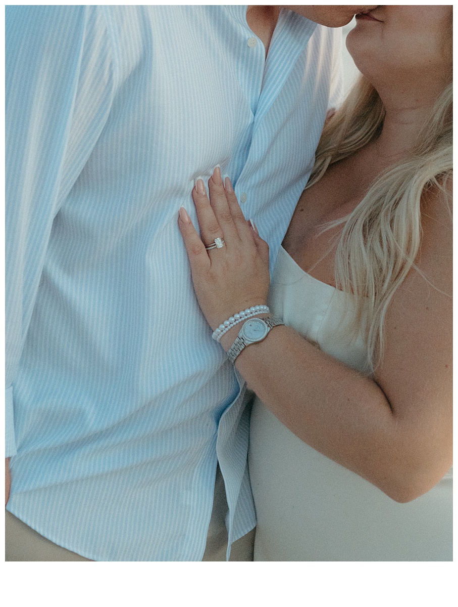 close up shot of bride ring on rooms chest at sunrise florida beach elopement