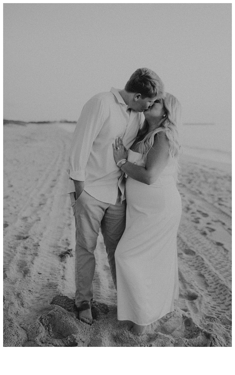 black and white photo of couple kissing during sunrise elopement