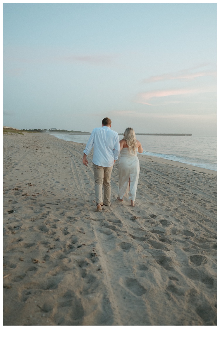 bride and groom at sunrise walking along beach at sebastian inlet beach