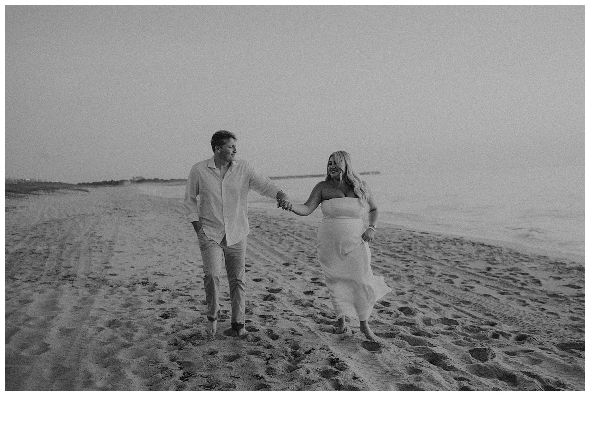 black and white playful photo of couple during their portraits after beach elopement