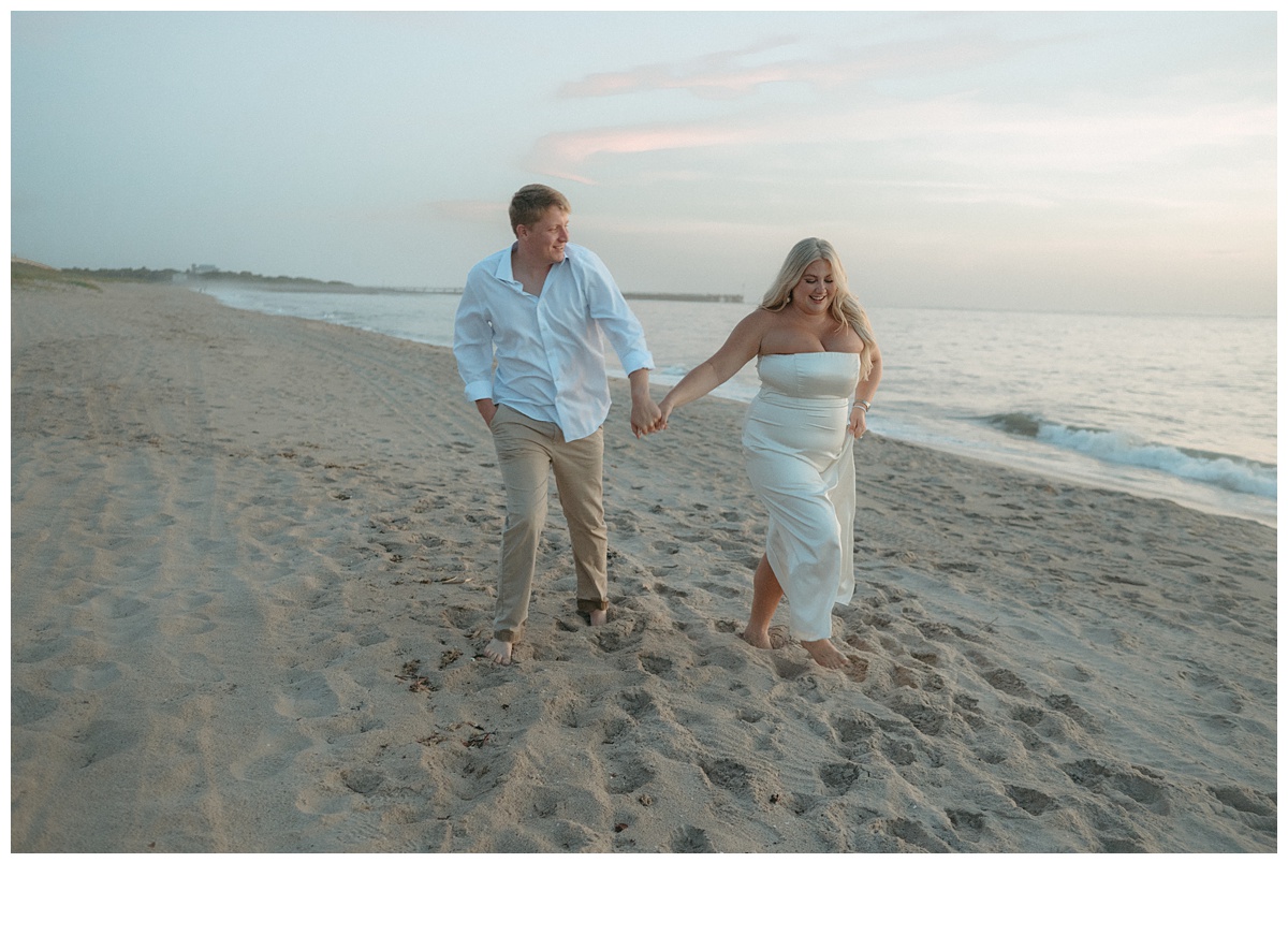 couple walking along beach after their florida beach elopement during sunrise