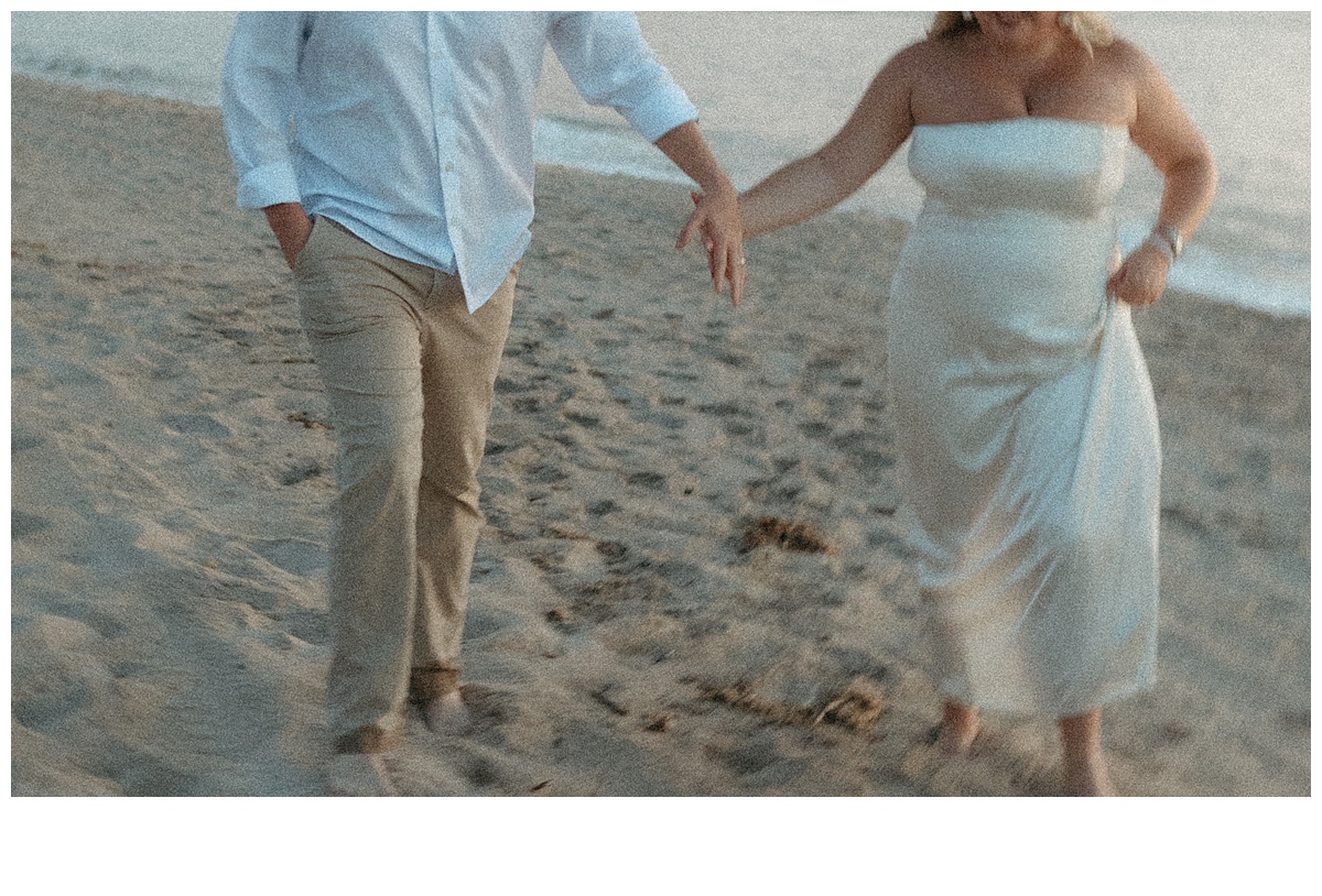 fun and unique photo of bride and grooms hands while running on florida beach