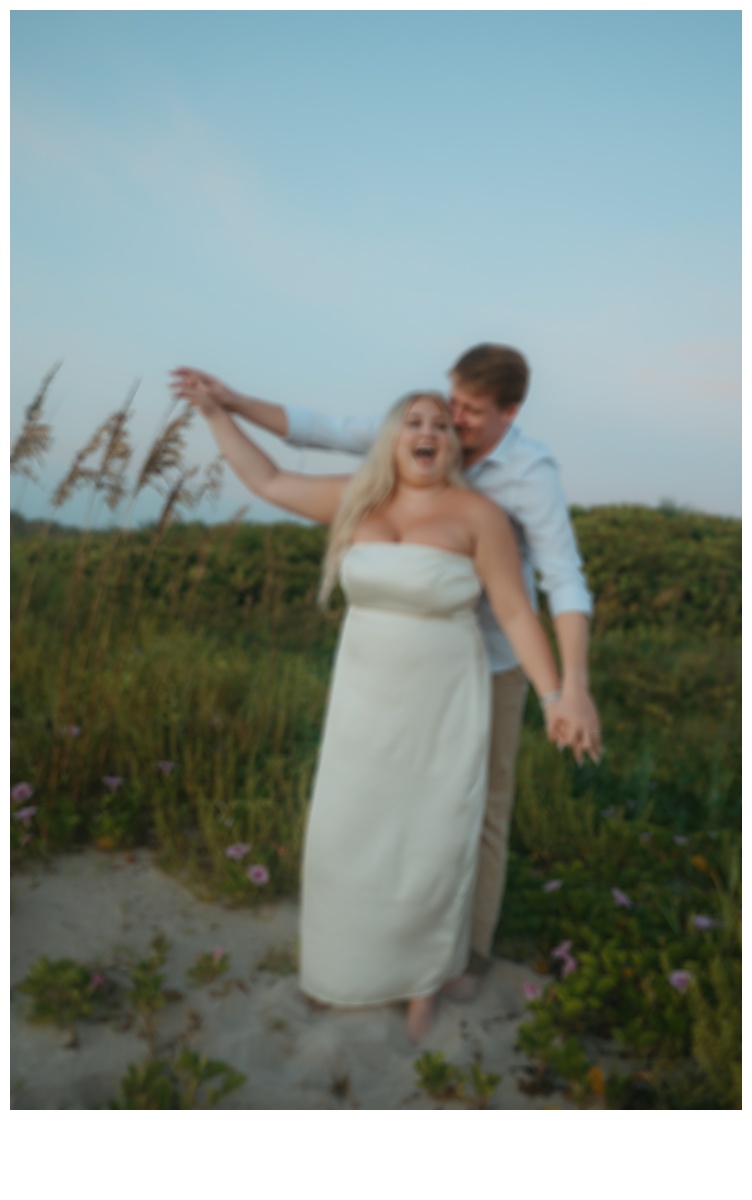 unique blurry bride and groom having fun and laughing while on a berm after florida beach elopement