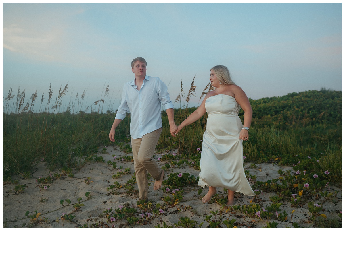 bride and groom walking down from berm at sebastian inlet beach after florida elopement