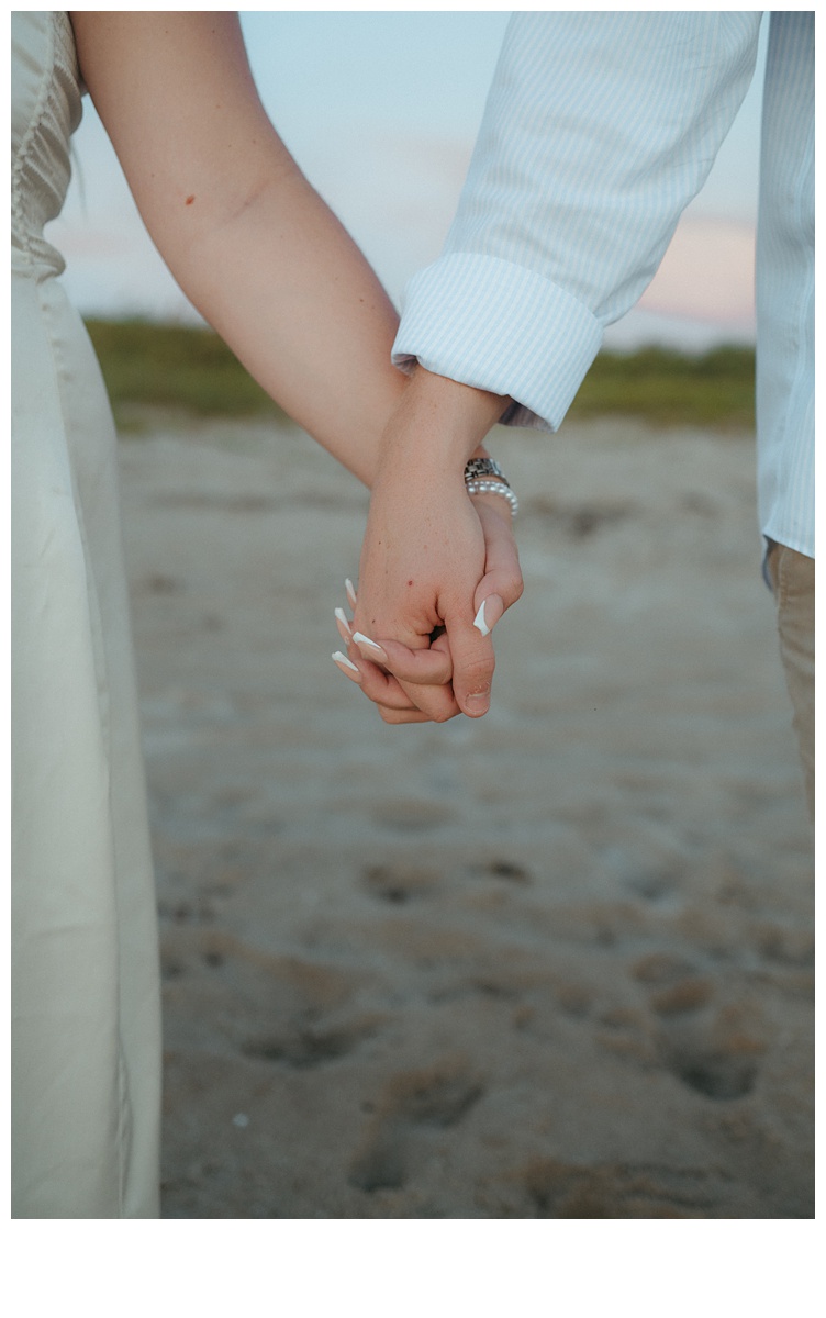 unique close up shot of bride and groom holding hands