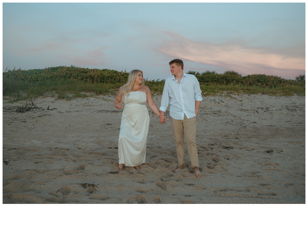 bride and groom posing while looking at one another after their florida beach elopement