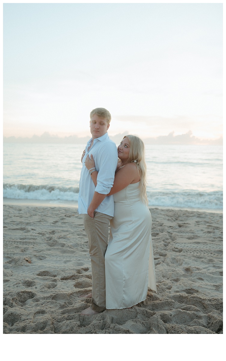 bride hugging groom from behind on sebastian inlet beach