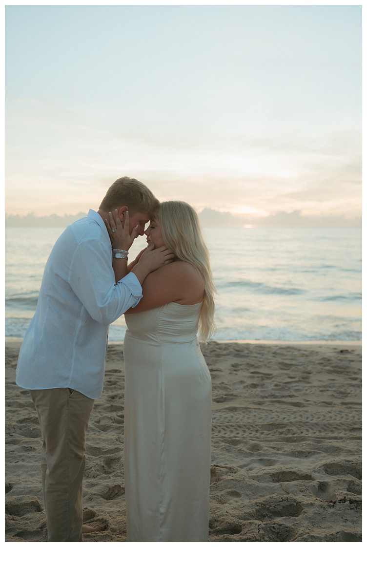 close up shot of couple forhead to forhead on sebsatian inlet beach at sunrise