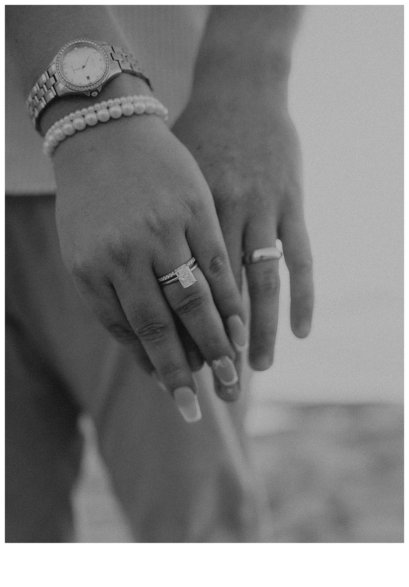 black and white close up of bride and grooms hands