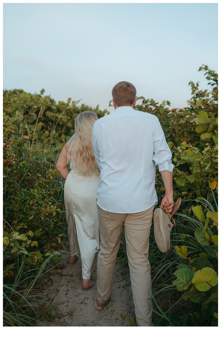 couple walking back from their beach elopement