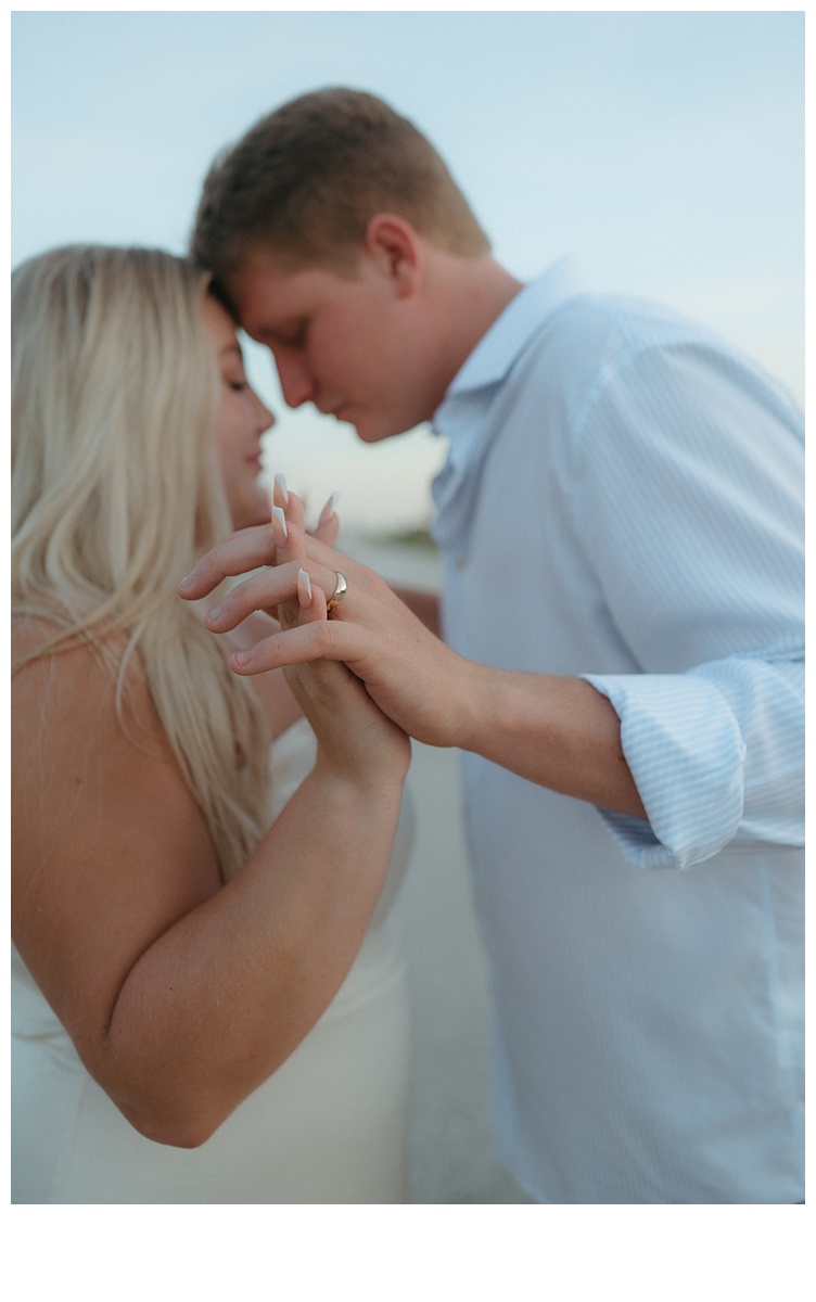 eloping couple intimate moment holding hands and nuzzling noses