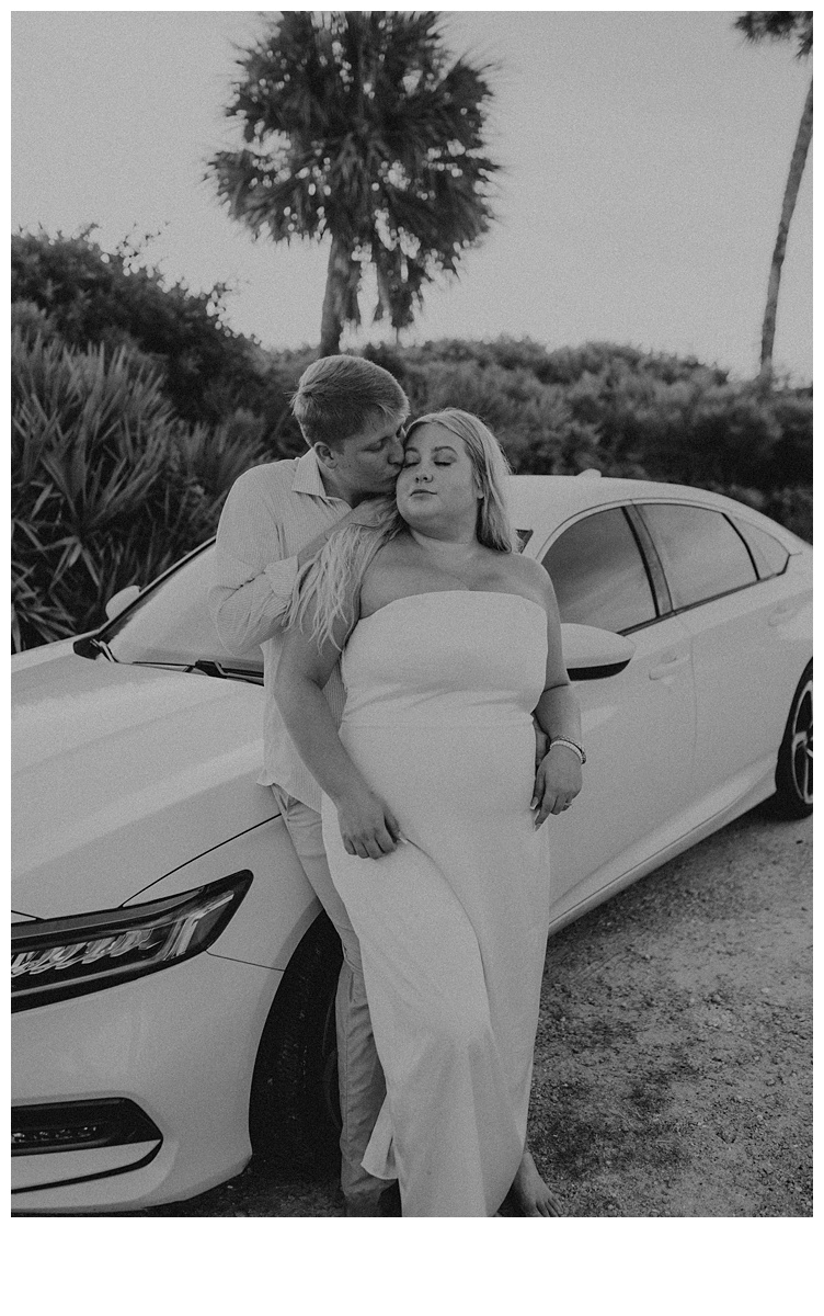 black and white couple cozied up together outside of sebastian inlet beach