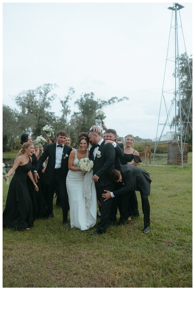 bridal party having fun with bride and groom