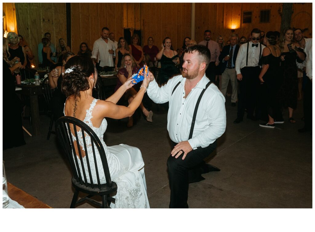 garter removal from groom during reception