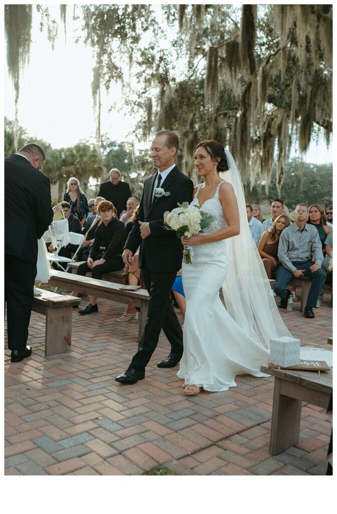 Bride walking down aisle with dad at black willow ranch Mims wedding venue