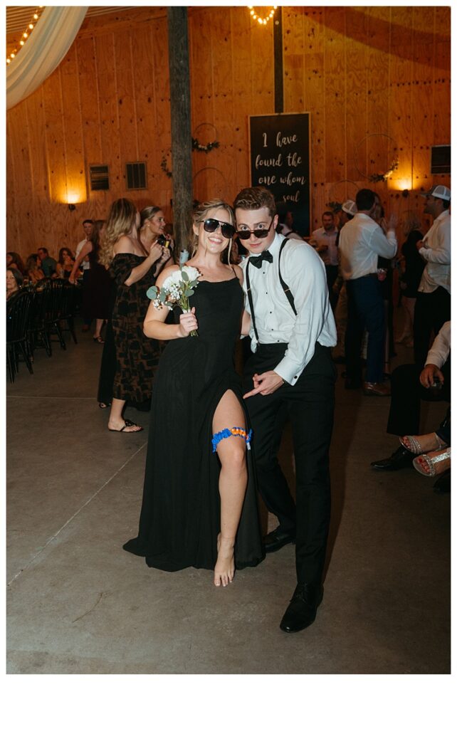 bridesmaid and groomsmen posing with garter and bouquet