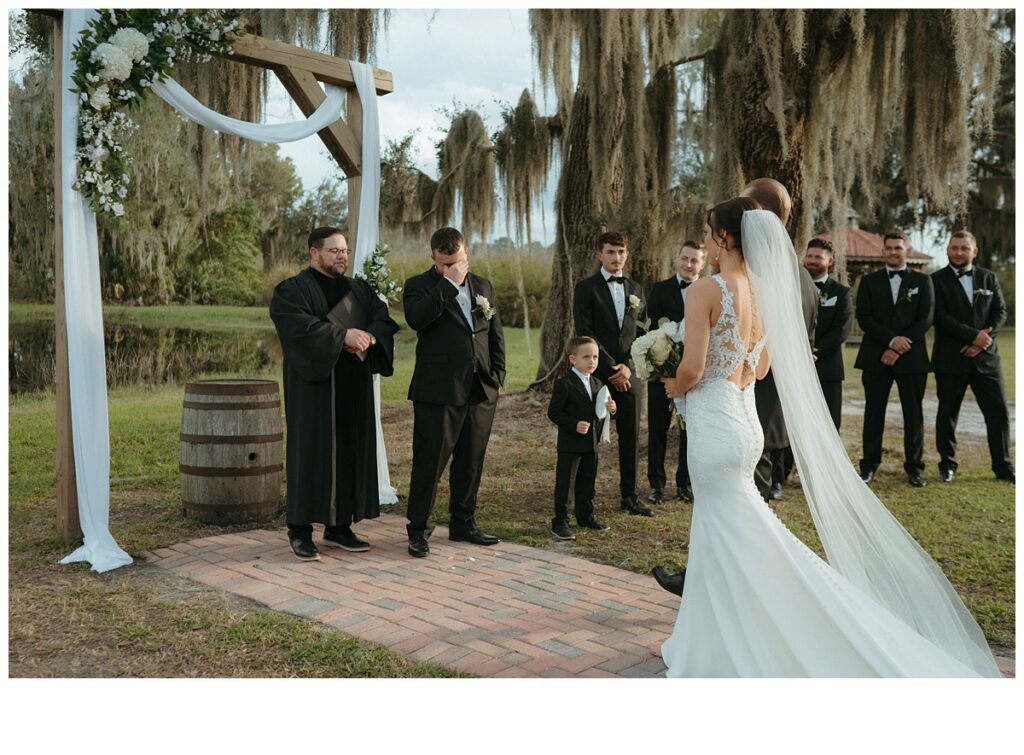 groom crying at altar at black willow ranch mims