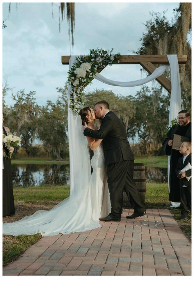 bride and groom kissing after i do's at black willow ranch mims