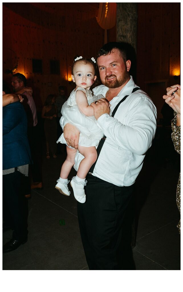 groom with daughter during reception dancing