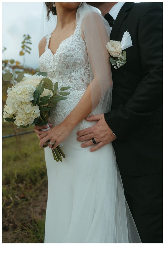 unique close up of bridal bouquet and groom hand