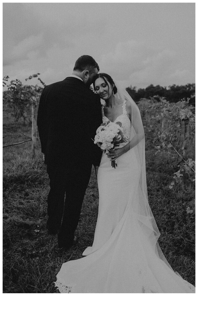 black and white bride and groom in vineyard