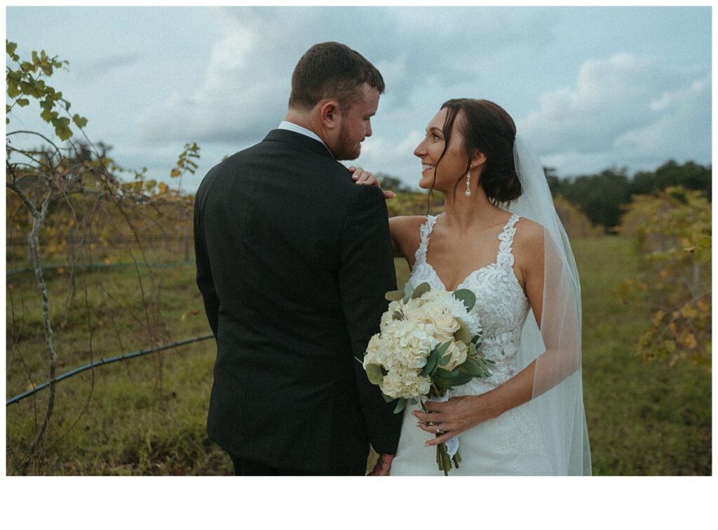 bride and groom smiling at each other