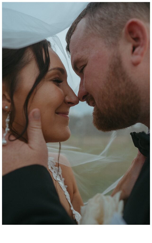 unique bride and groom under veil photo