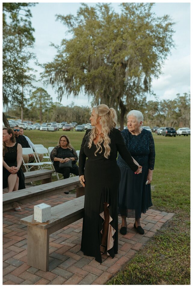 bride mother and grandma watching as bride walks down aisle