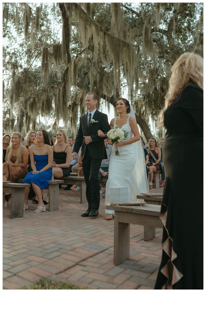 bride walking down aisle with dad