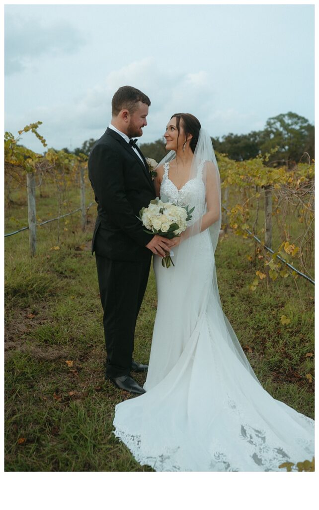 groom and bride looking at each other smiling