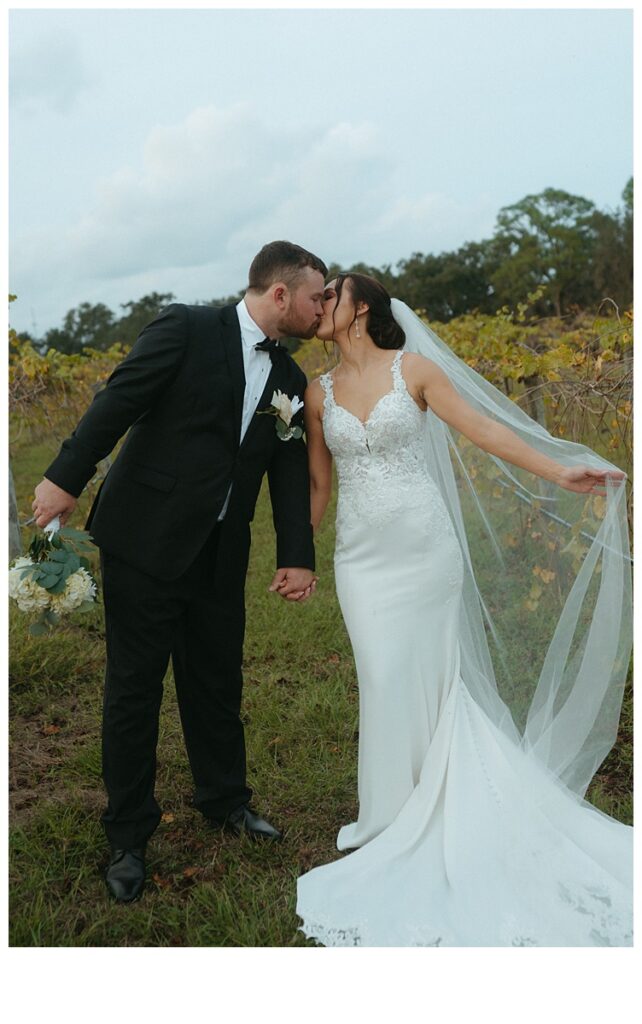 fun bride and groom kissing