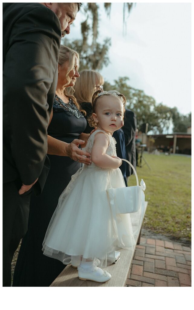 flower girl watching as bride walks down the aisle