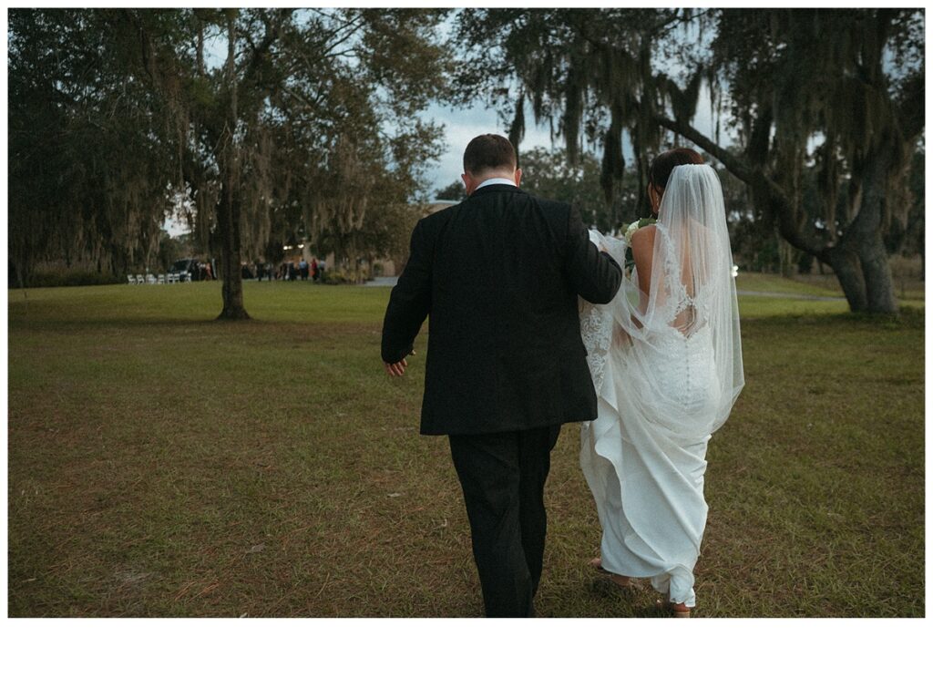 bride and groom walking to reception at black willow ranch mims