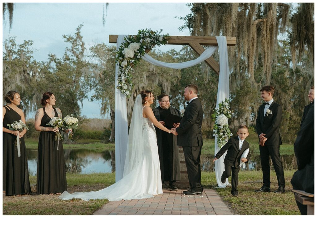 bride and groom holding hands during ceremony