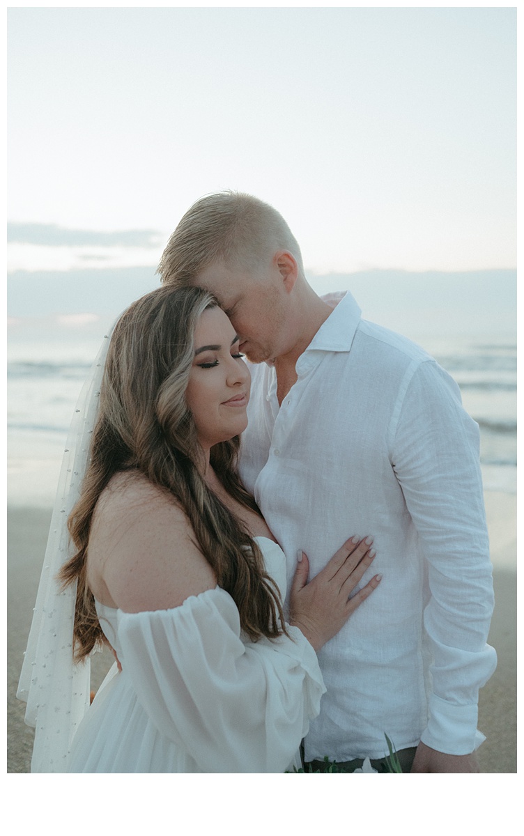 up close bride and groom share intimate moment on beach