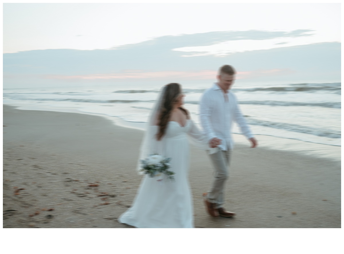 fun blurry photo of bride and groom running on beach