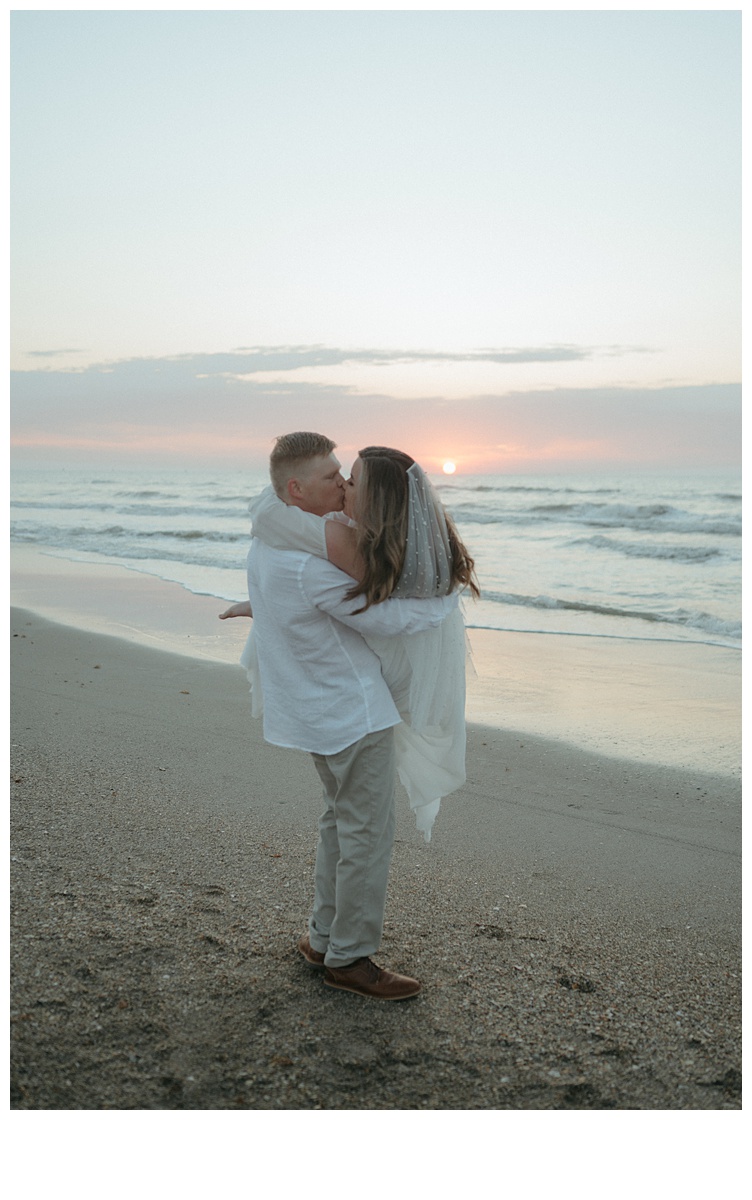 bride and groom kissing and spinning