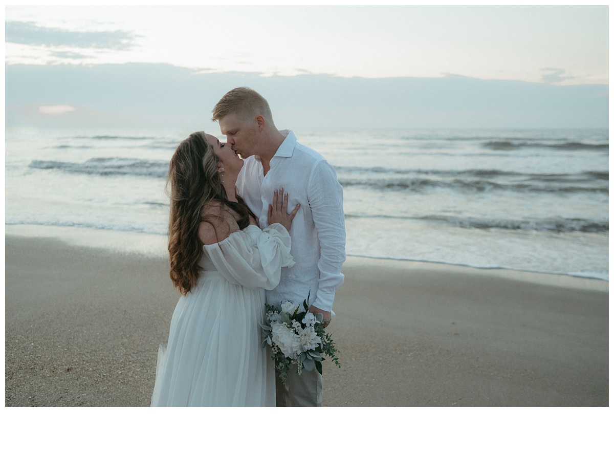 bride and groom kiss after beach elopement