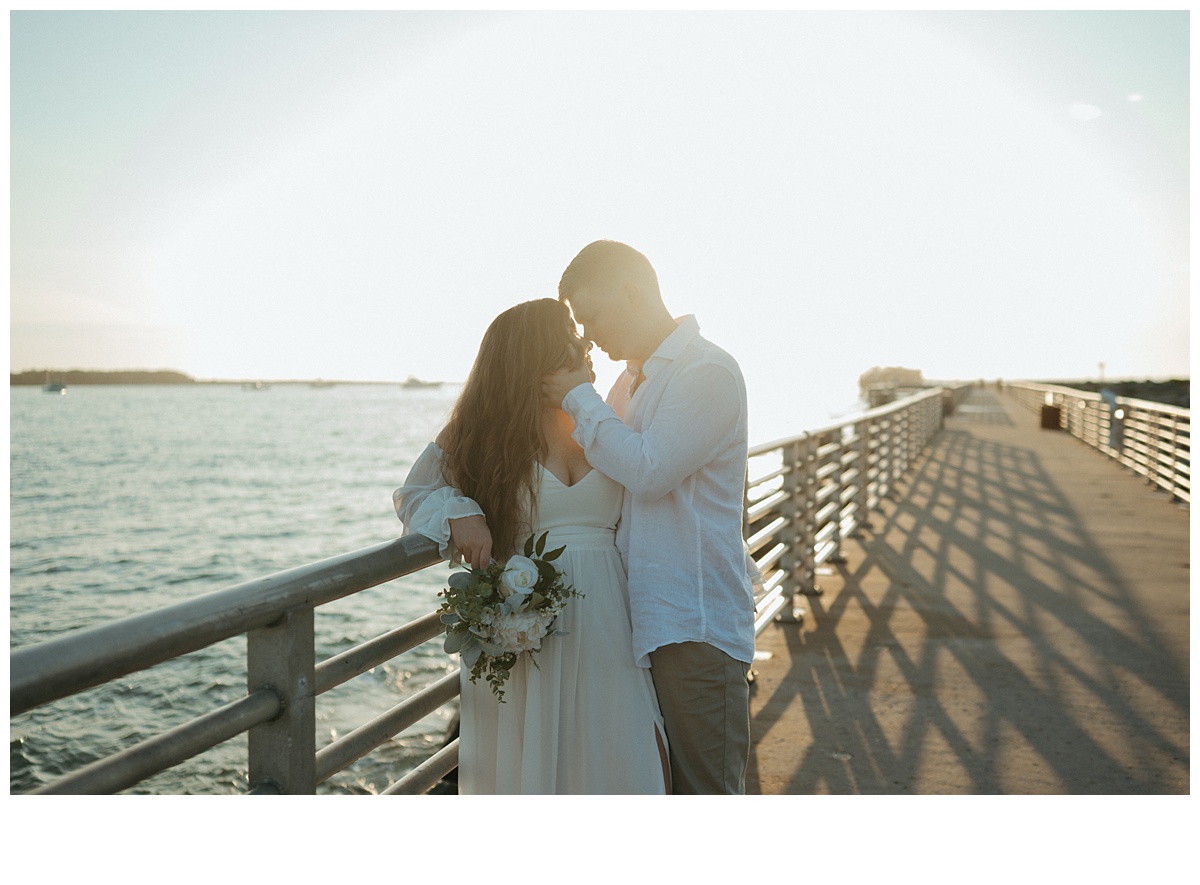 bride and groom on boardwalk of jetty park