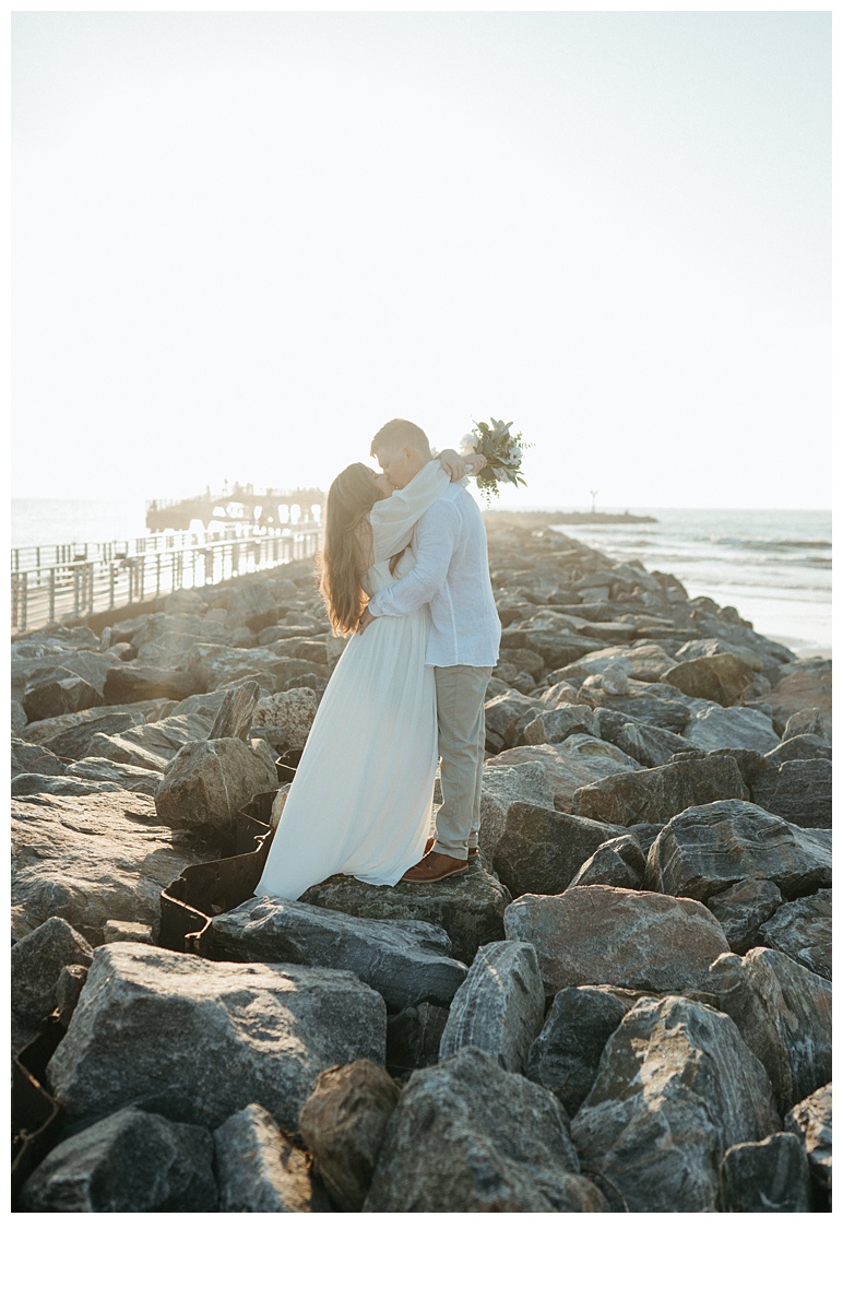 bride and groom in a warm embrace at the beach