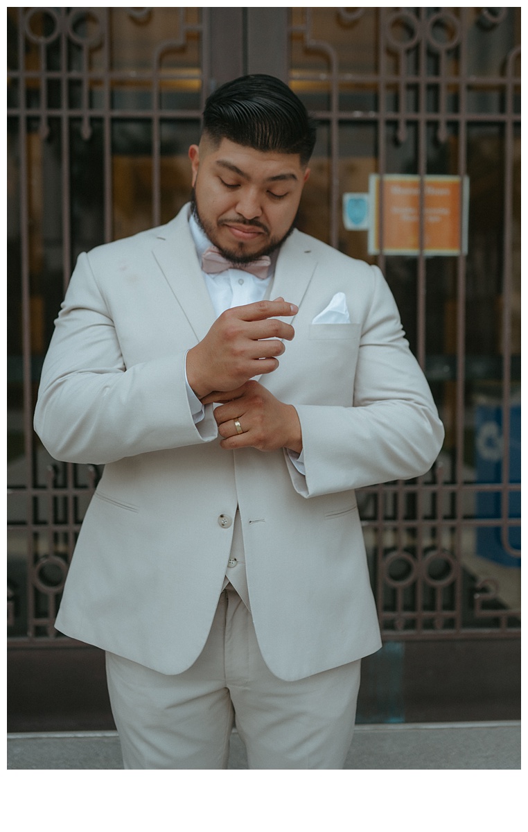 groom fixing the cuffs of his sleeve 