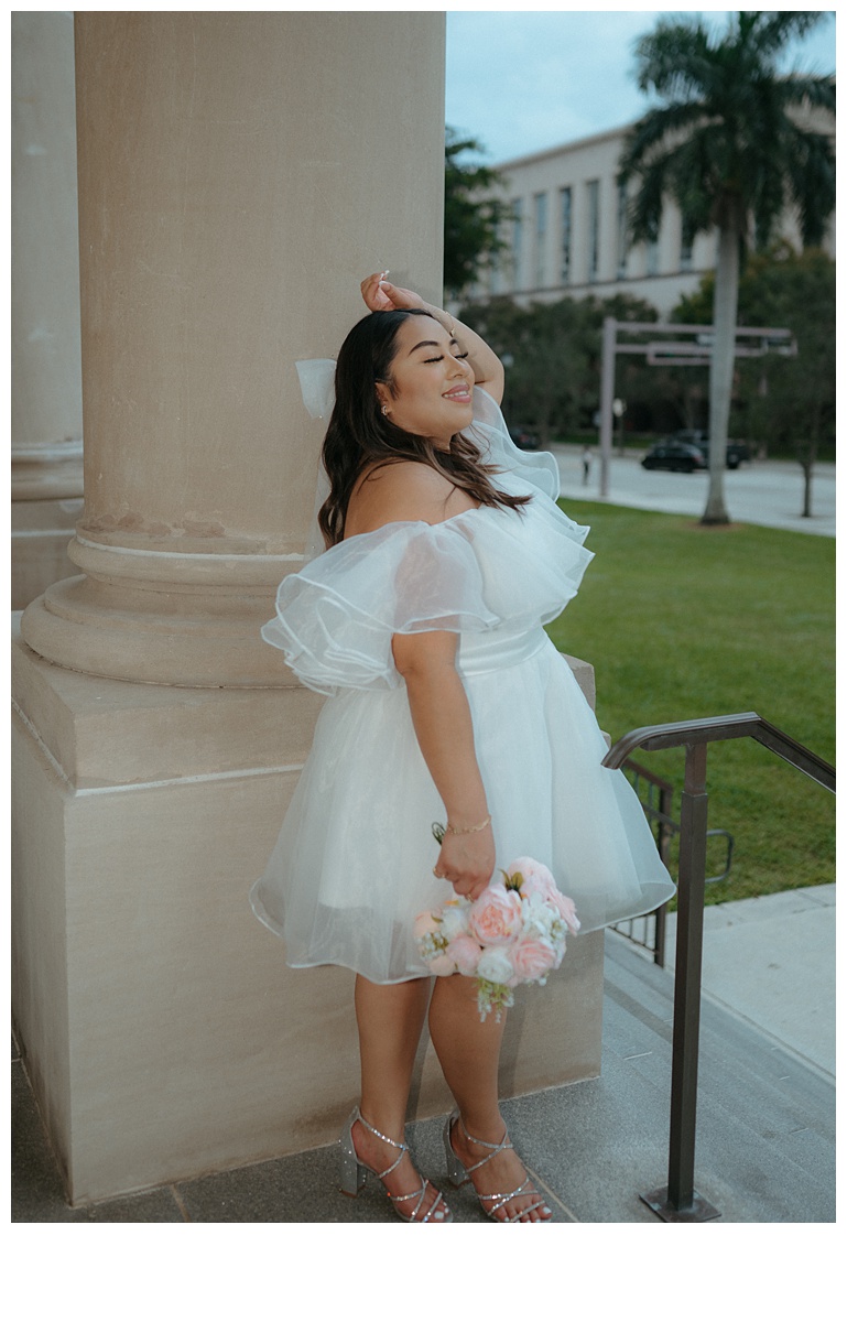 fun flash photo of bride soaking in the breeze on courthouse steps in palm beach