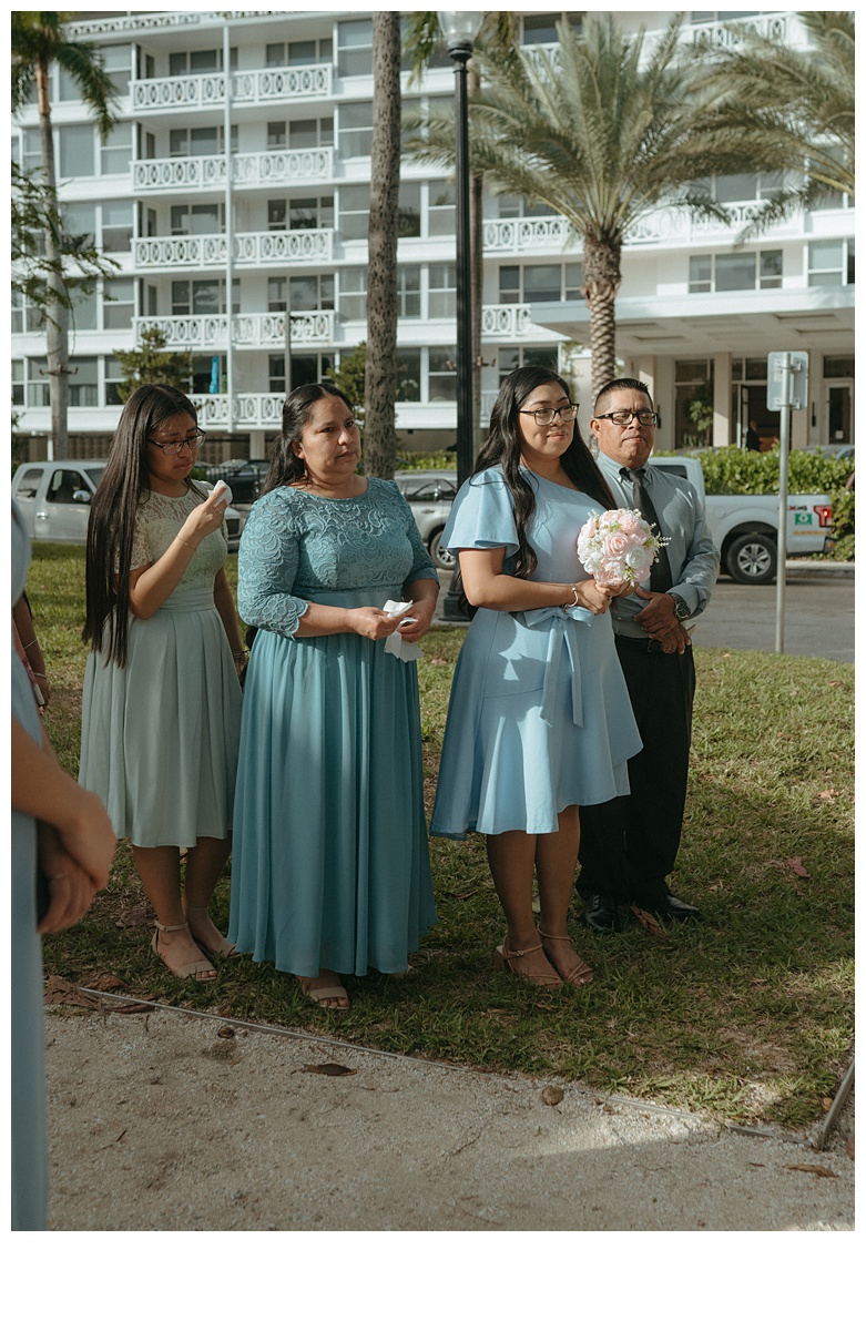 emotional brides family watching during elopement ceremony