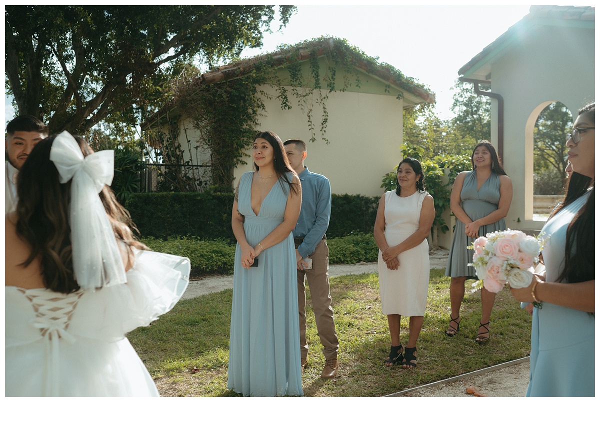 wide shot brides family watching during ceremony