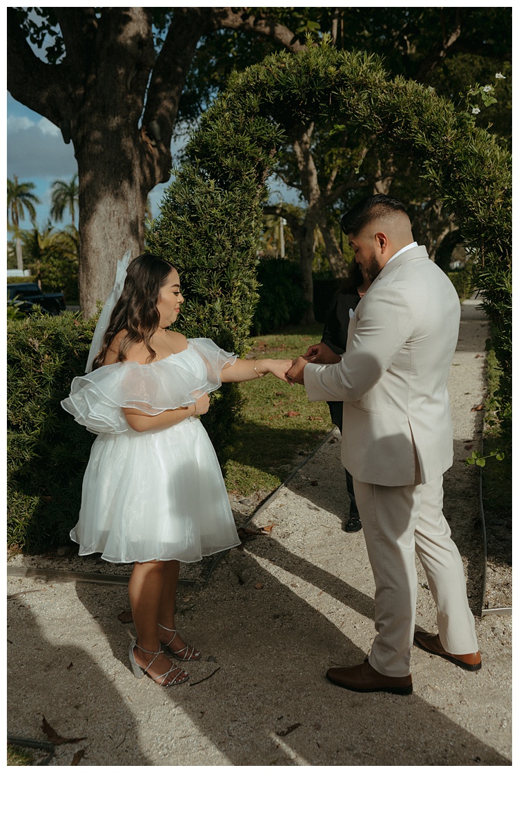 groom putting ring on bride during elopement ceremony