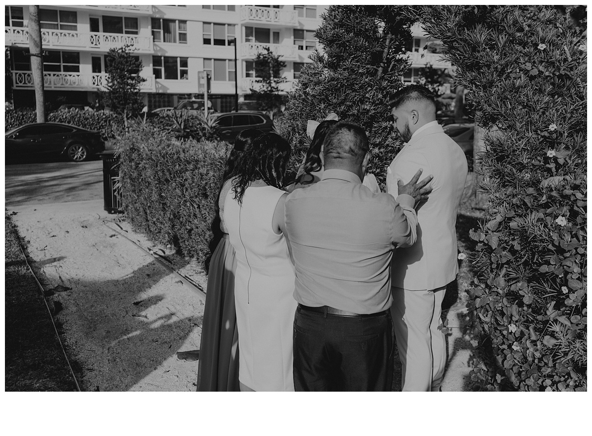 Emotional black and white moment, couples parents praying over them