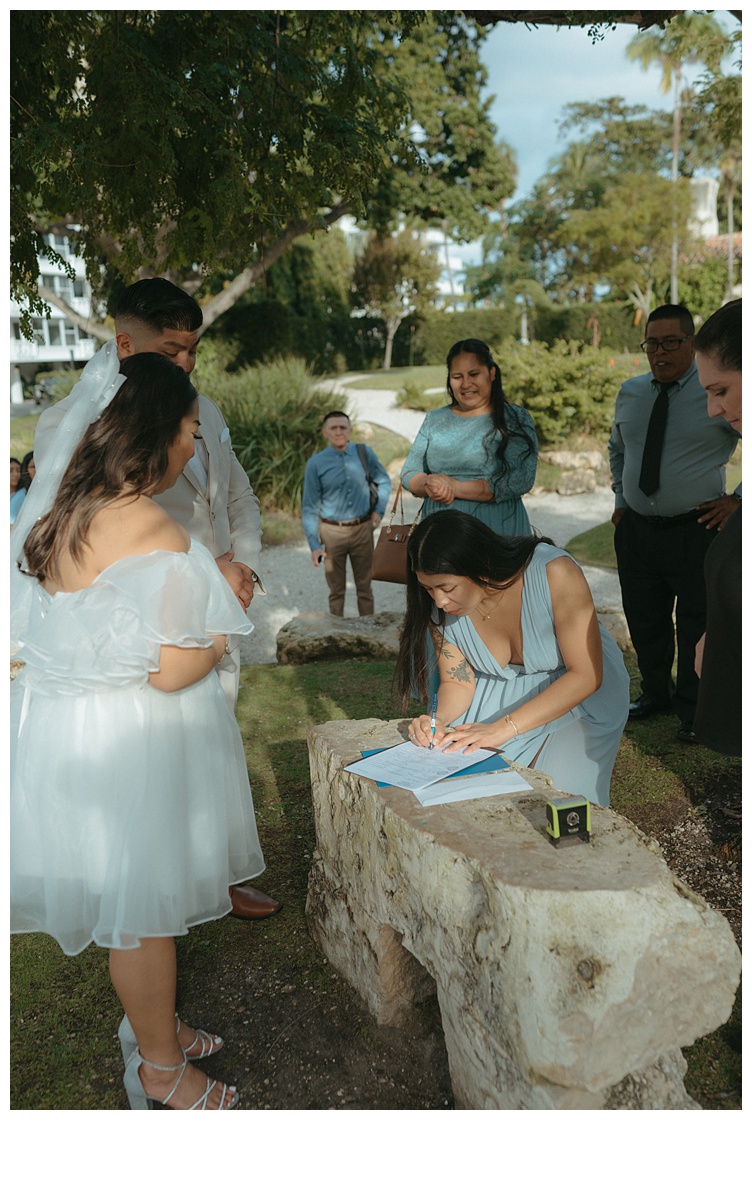 groom sister signing marriage license as witness