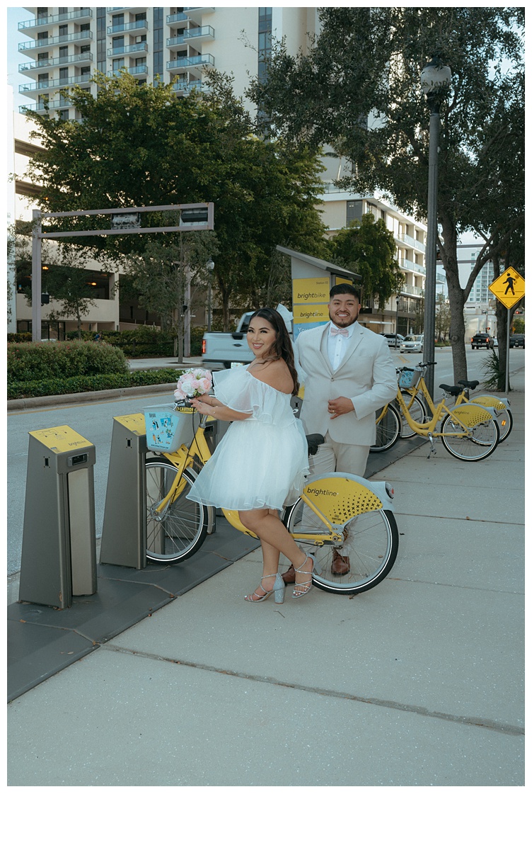 bride and groom taking out city bikes for a ride