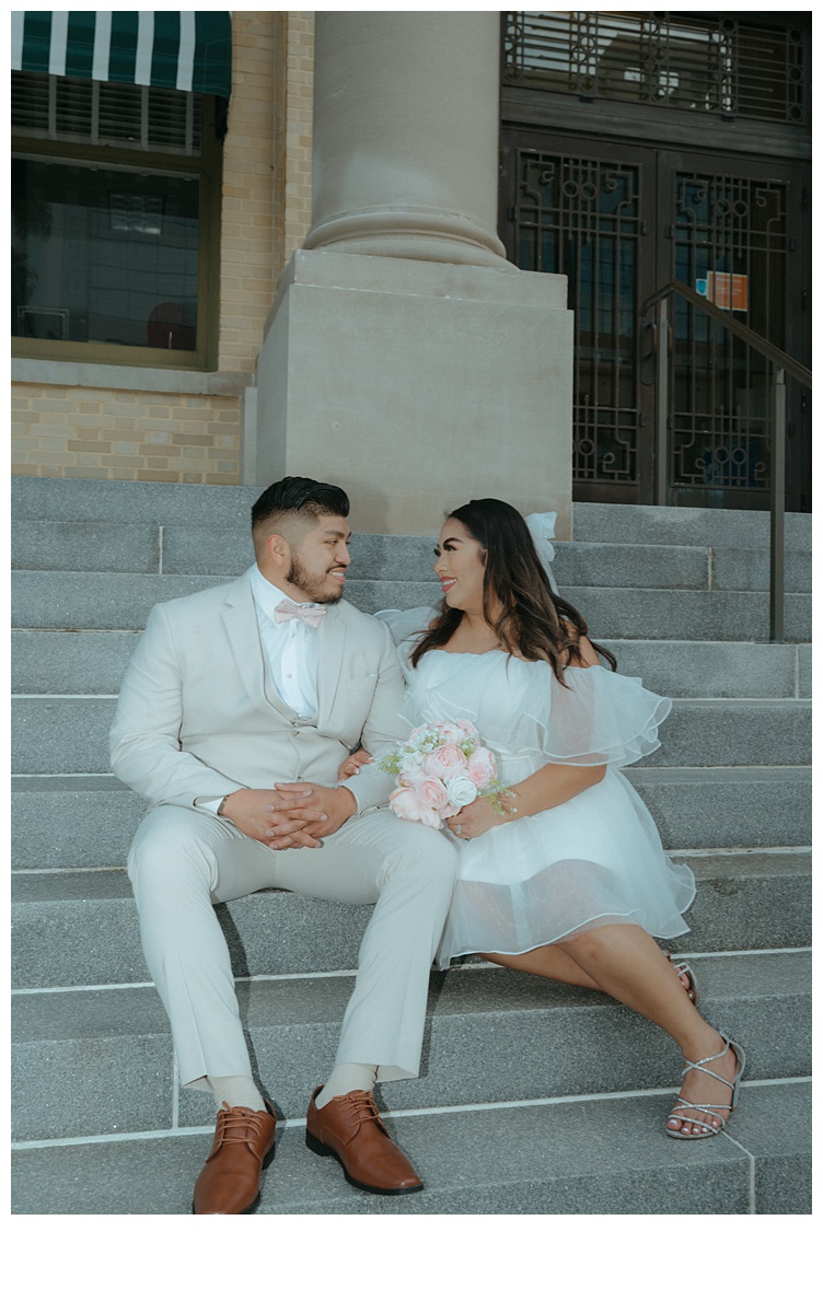 flash photo of bride and groom sitting on steps