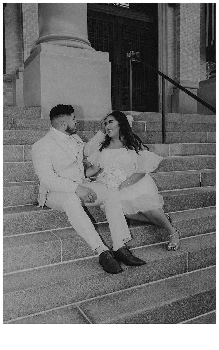 groom and bride having fun moment on steps at palm beach courthouse steps